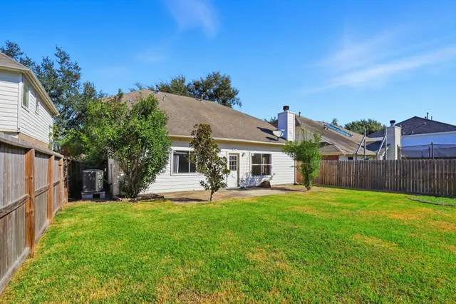 a view of a house with a yard and sitting area