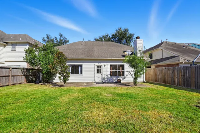 a view of a house with a yard and sitting area