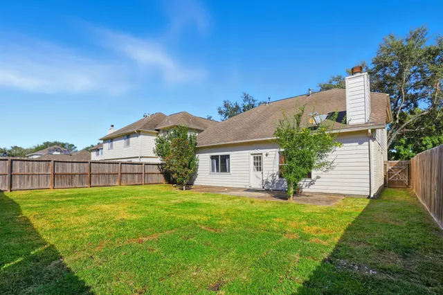 a view of a house with a yard and plants