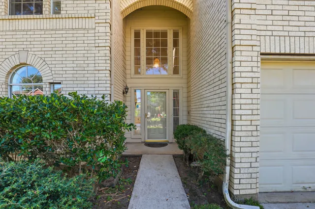 a view of a brick house with potted plants