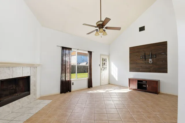 a view of a livingroom with a fireplace and window