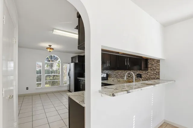a kitchen with sink and large mirror