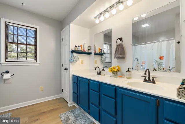 a bathroom with a double vanity sink and a mirror