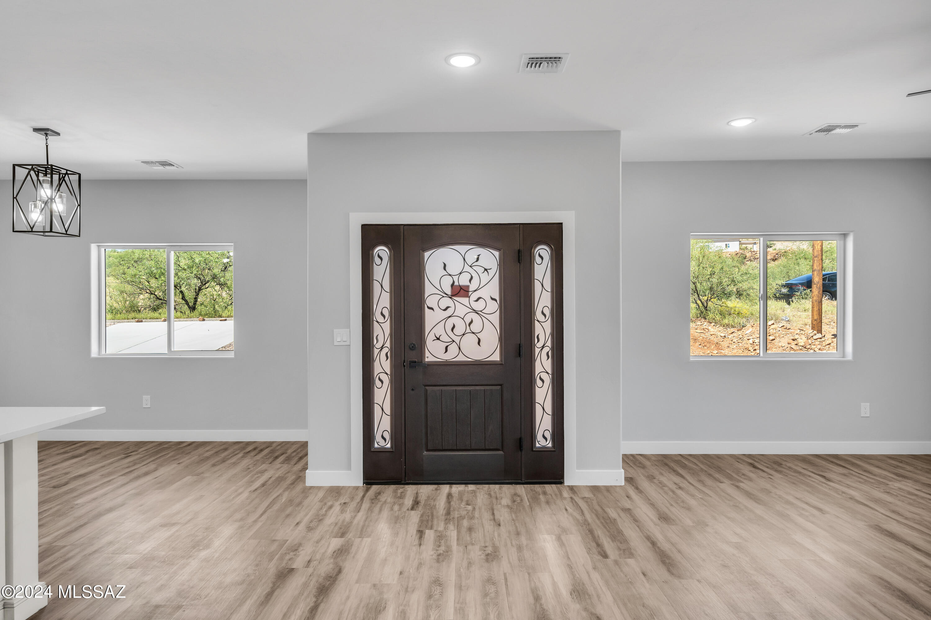 1849 Circulo Mexicali Rio Rico, AZ 85648 - Photo 4 of 29 wooden floor in an empty room with a window