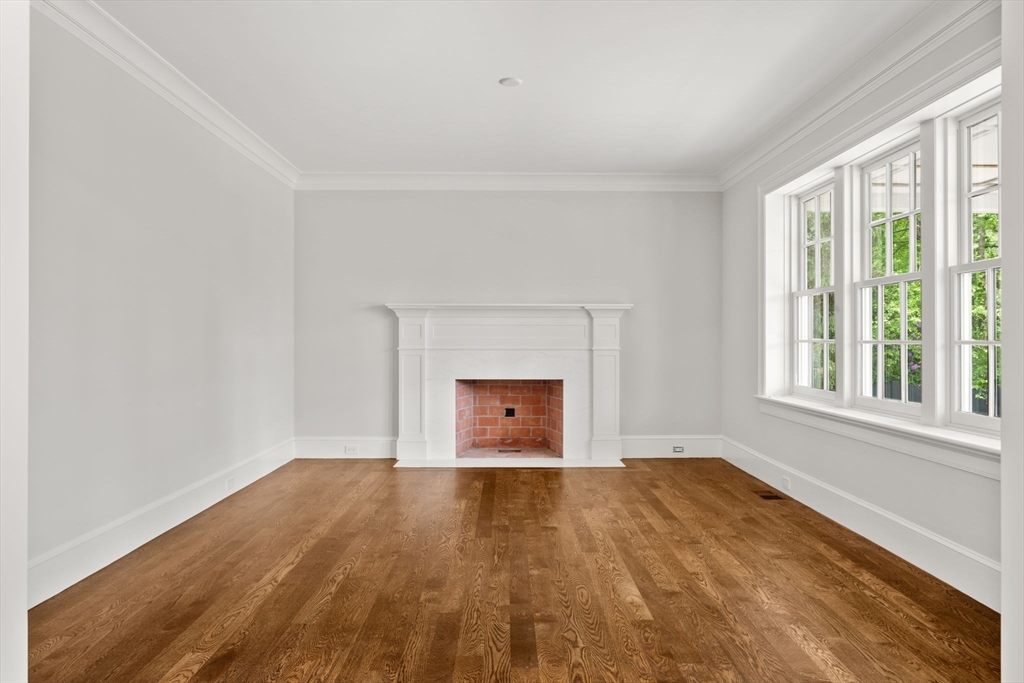 61 Heath Street Brookline, MA 02467 - Photo 14 of 40 a view of an empty room with a window and wooden floor