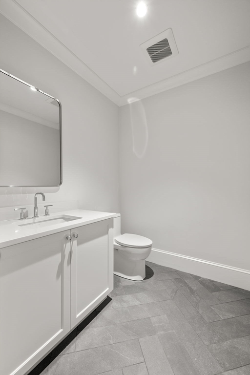 61 Heath Street Brookline, MA 02467 - Photo 20 of 40 a bathroom with a toilet sink and mirror