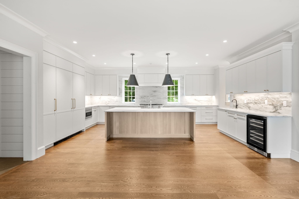 61 Heath Street Brookline, MA 02467 - Photo 2 of 40 a large kitchen with stainless steel appliances kitchen island granite countertop a large counter top and white cabinets
