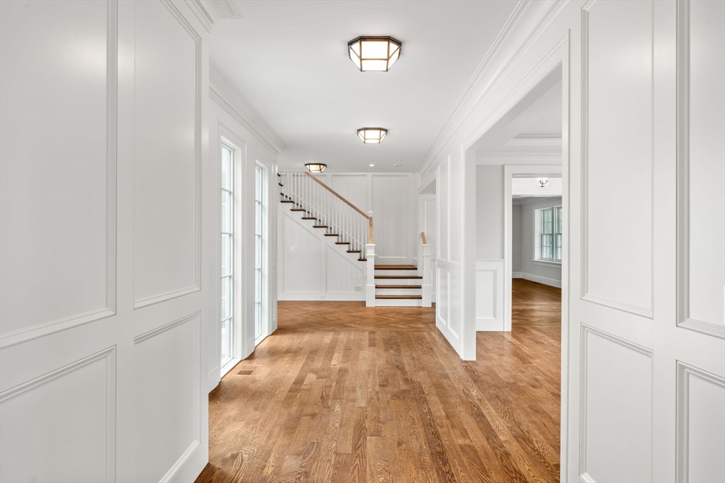 61 Heath Street Brookline, MA 02467 - Photo 24 of 40 a view of a hallway with wooden floor and staircase