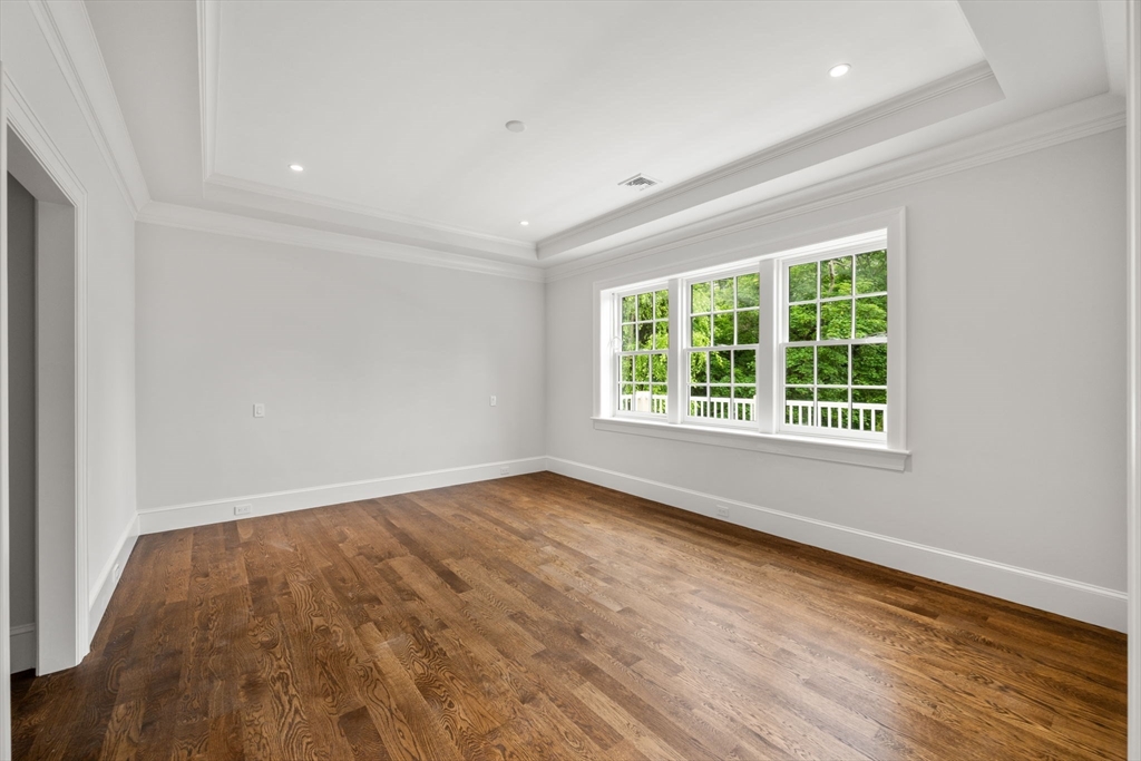 61 Heath Street Brookline, MA 02467 - Photo 26 of 40 a view of an empty room with wooden floor and a window