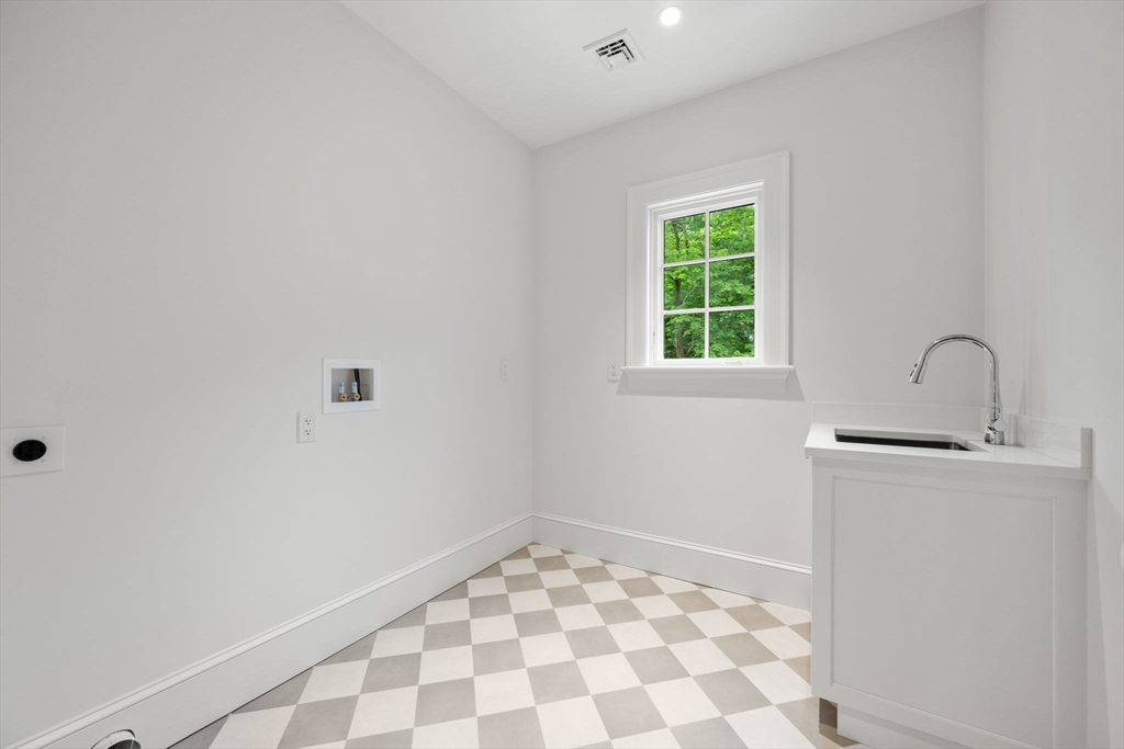 61 Heath Street Brookline, MA 02467 - Photo 38 of 40 a bathroom with a sink toilet and window