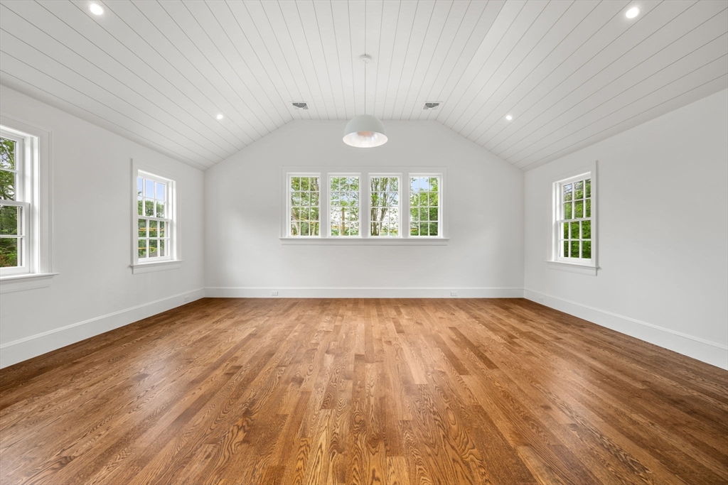 61 Heath Street Brookline, MA 02467 - Photo 39 of 40 an empty room with wooden floor and windows