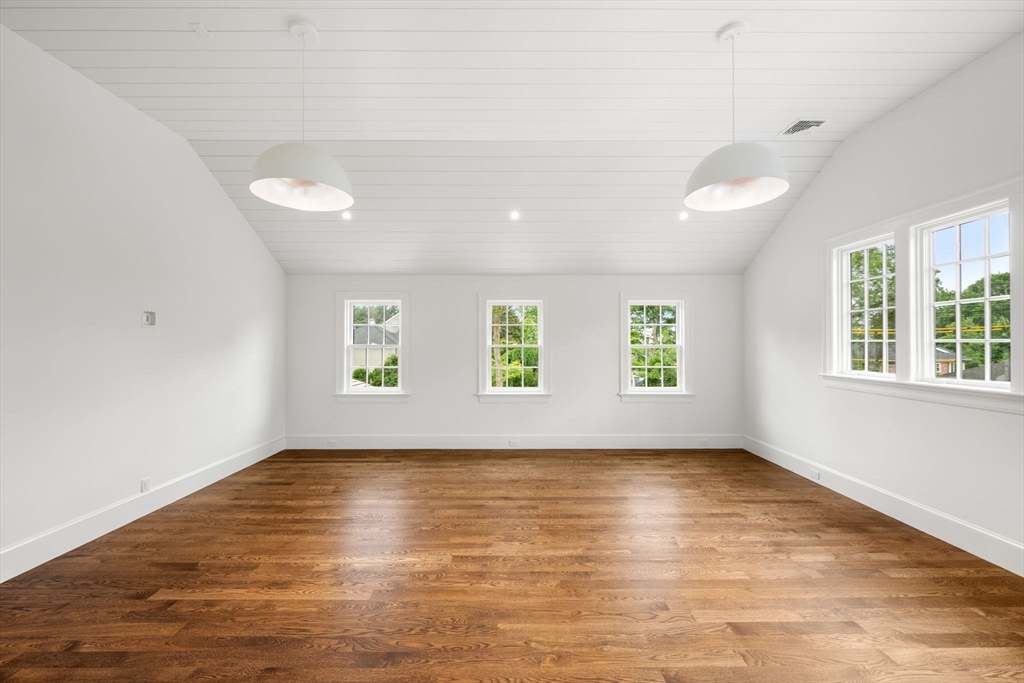 61 Heath Street Brookline, MA 02467 - Photo 40 of 40 an empty room with wooden floor and windows
