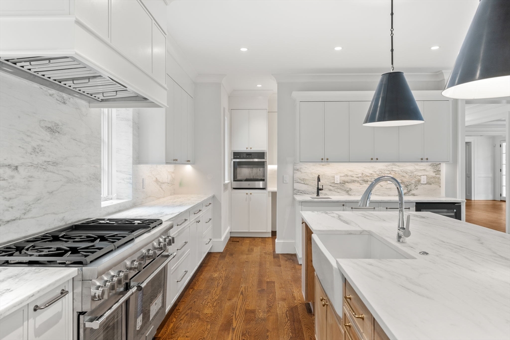 61 Heath Street Brookline, MA 02467 - Photo 4 of 40 a kitchen with stainless steel appliances granite countertop a sink stove and refrigerator