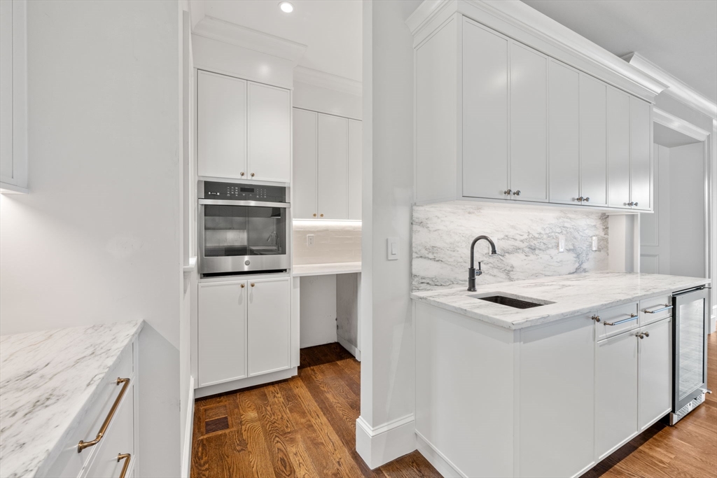 61 Heath Street Brookline, MA 02467 - Photo 5 of 40 a kitchen with stainless steel appliances granite countertop a sink stove and white cabinets