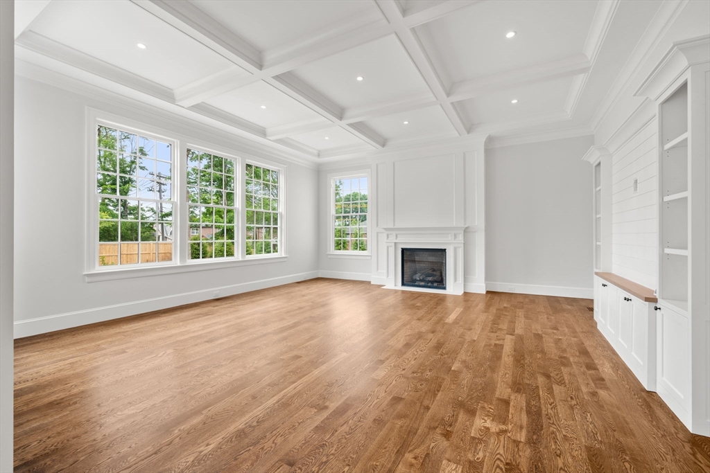 61 Heath Street Brookline, MA 02467 - Photo 8 of 40 an empty room with wooden floor and a fireplace