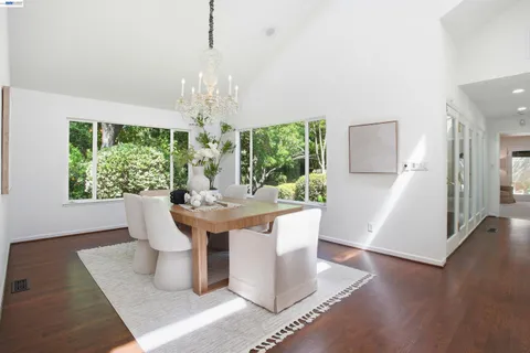 a view of a dining room with furniture and chandelier