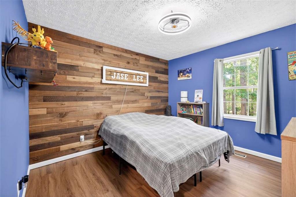 386 Ridgewood Drive Pendergrass, GA 30567 - Photo 22 of 50 a bedroom with a bed and a mirror