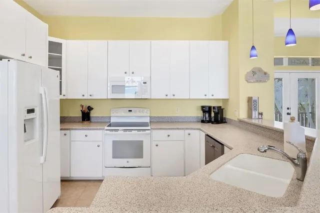 a large kitchen with lots of counter space and windows