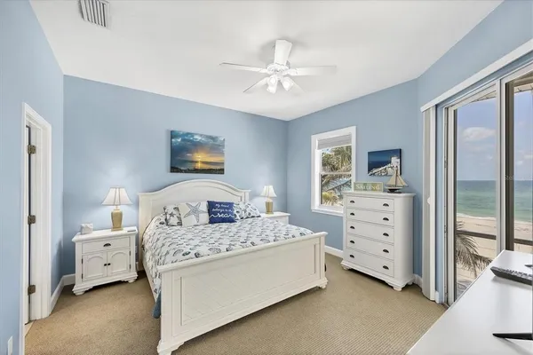 a bedroom with a large bed and a flat tv screen on dresser