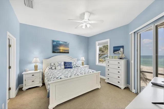 a bedroom with a large bed and a flat tv screen on dresser