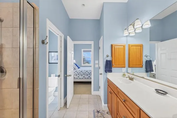 a bathroom with a tub sink and mirror