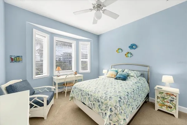 a bedroom with two beds and a window