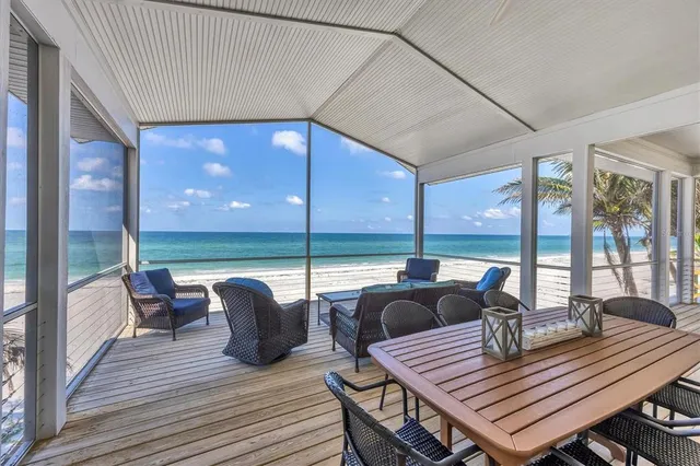 a view of a living room and floor to ceiling window wooden floor