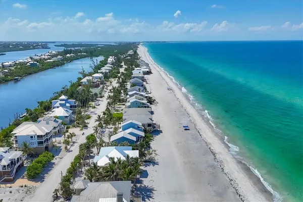 an aerial view of a house with a garden and car parked