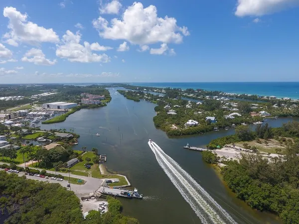 a sign that is on the street next to a yard