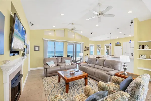 a living room with furniture fireplace and a chandelier