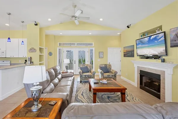 a living room with furniture a flat screen tv and a fireplace