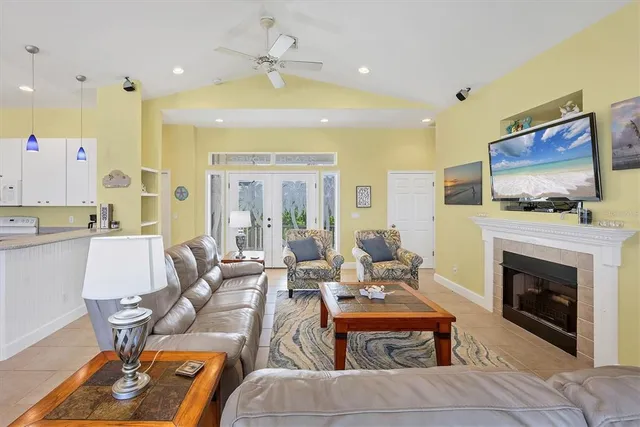 a living room with furniture a flat screen tv and a fireplace