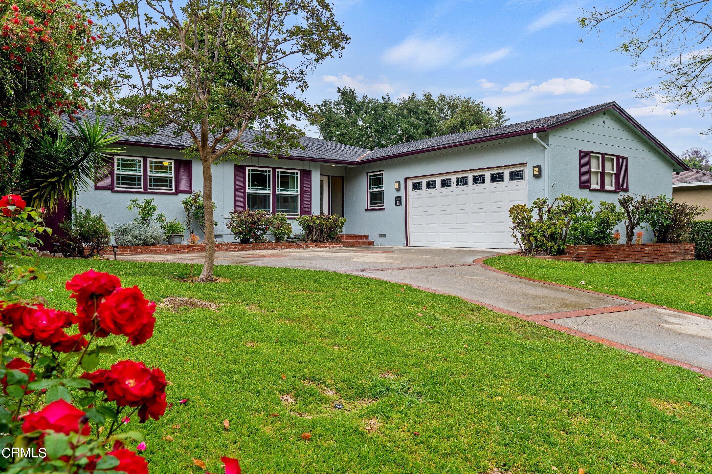 a front view of house with yard and outdoor seating