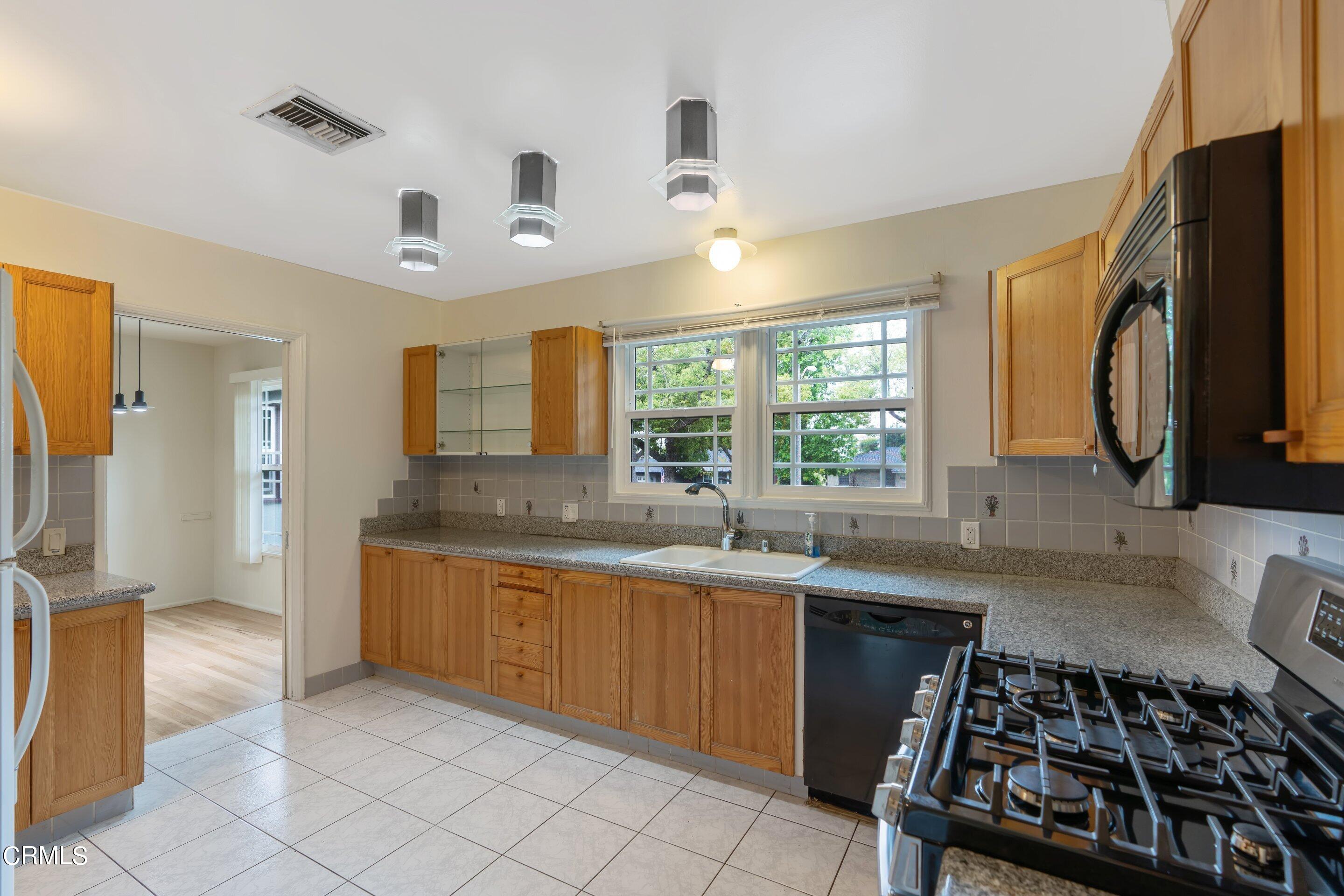 3815 Mayfair Drive Pasadena, CA 91107 - Photo 14 of 38 a kitchen with stainless steel appliances granite countertop a sink and a stove