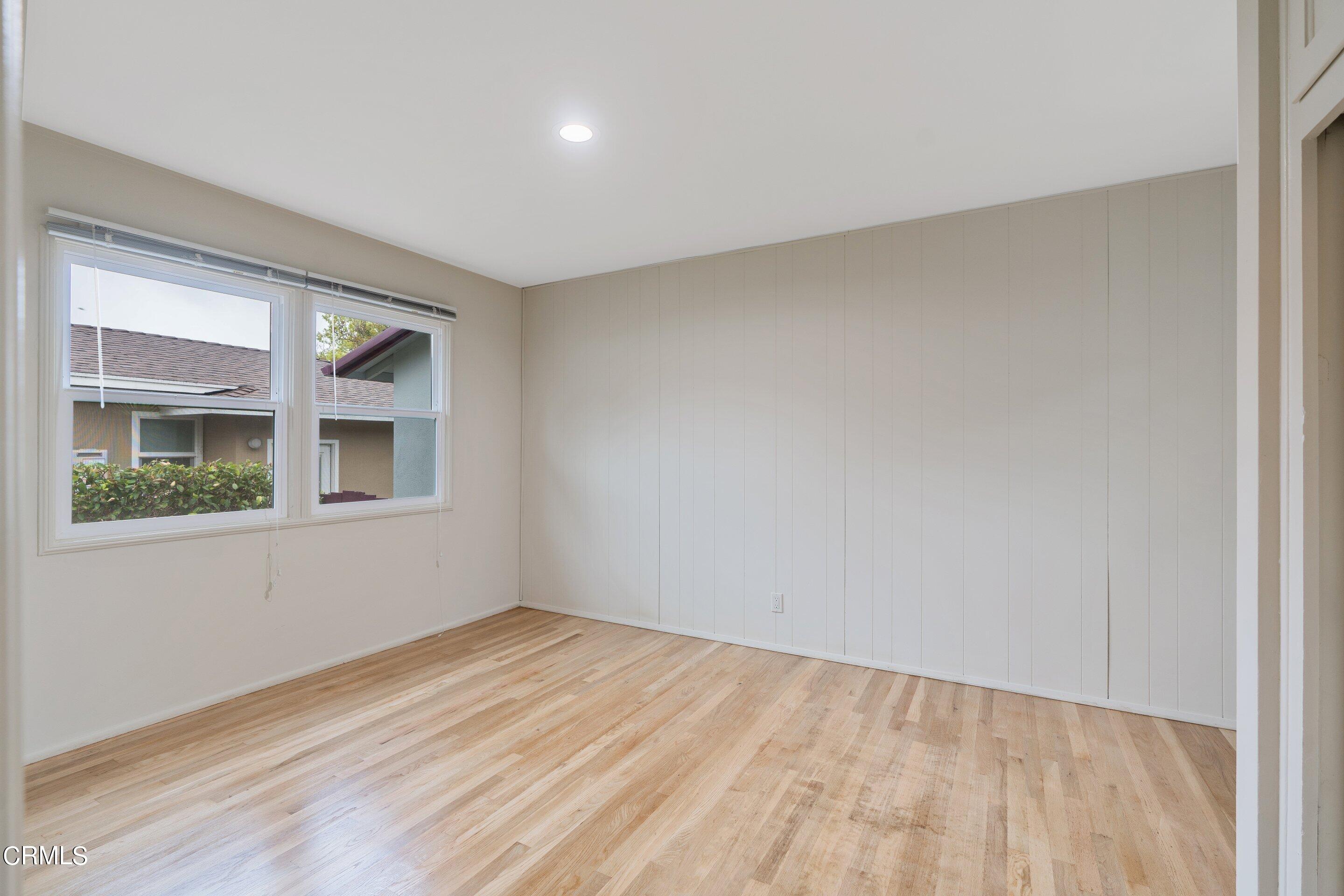 3815 Mayfair Drive Pasadena, CA 91107 - Photo 19 of 38 a view of an empty room with wooden floor and a window