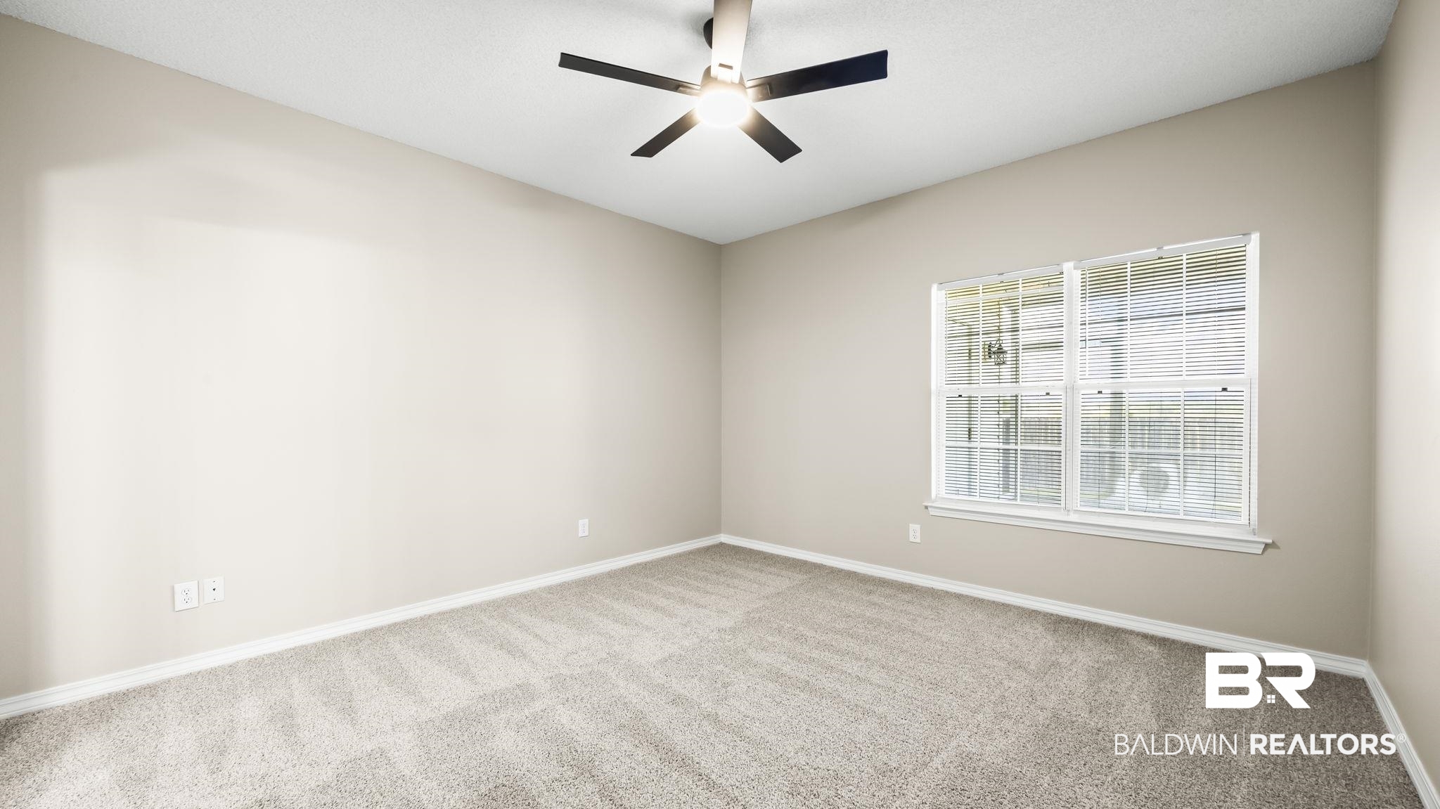 2651 South Juniper Street, Unit 705 Foley, AL 36535 - Photo 22 of 37 Neutral-toned walls complement the textured gray carpeting