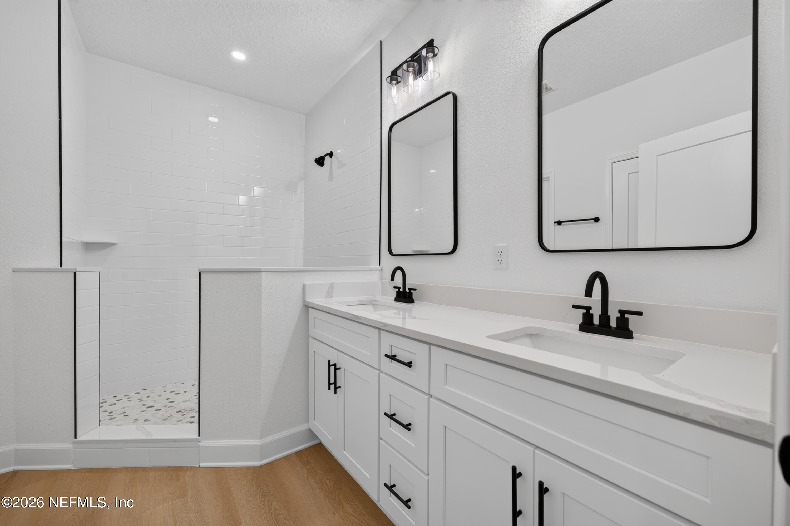 4362 Angora Street Middleburg, FL 32068 - Photo 12 of 31 a bathroom with double vanity sink two mirror and window