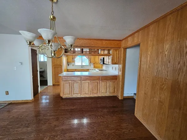 a view of spacious kitchen with a table and chairs