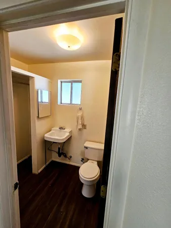 a bathroom with a toilet a sink and a mirror