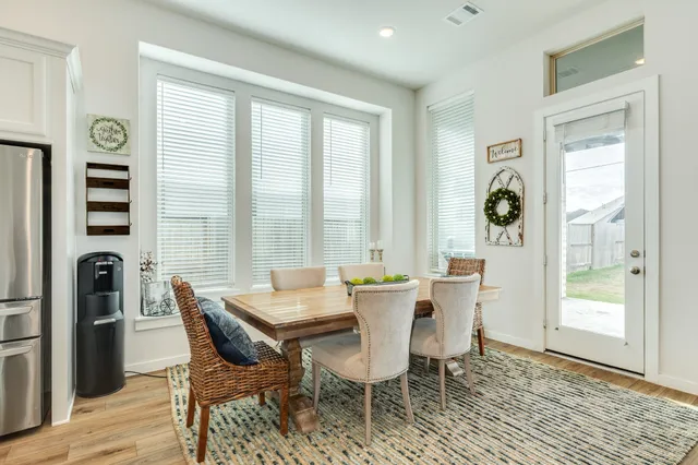 a view of a dining room with furniture and window