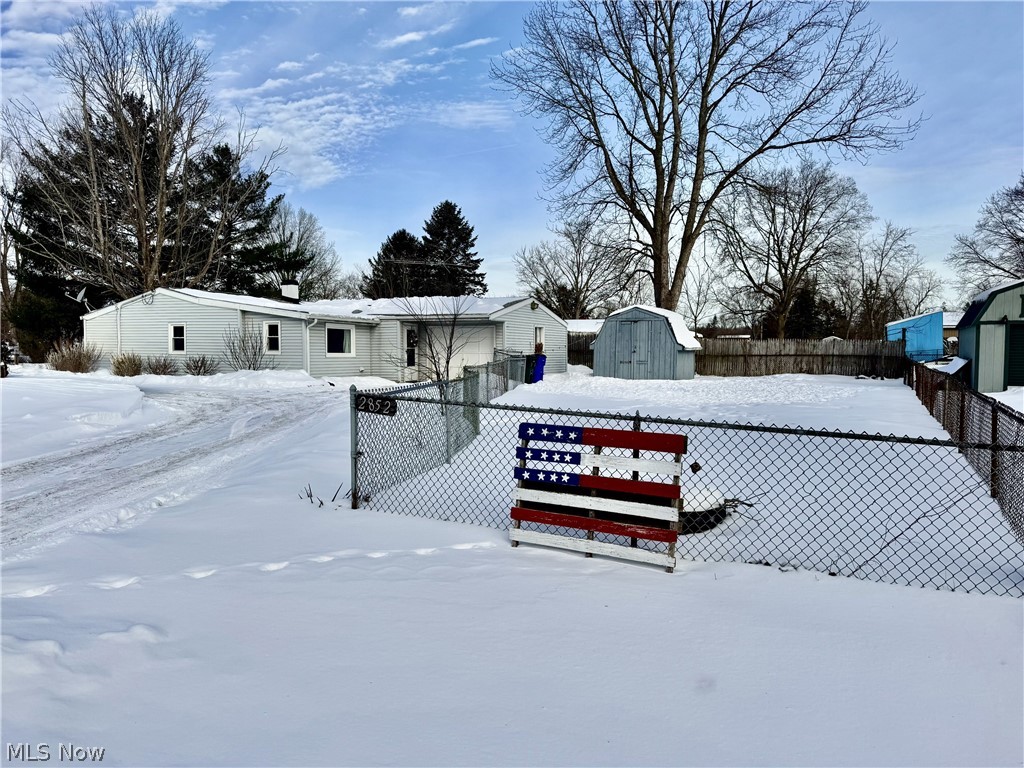 2852 Shelly Road Ravenna, OH 44266 - Photo 28 of 30 Snowy yard with a storage unit and a fenced backyard