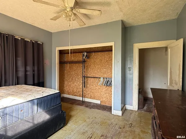 a bed sitting in a bedroom next to a window