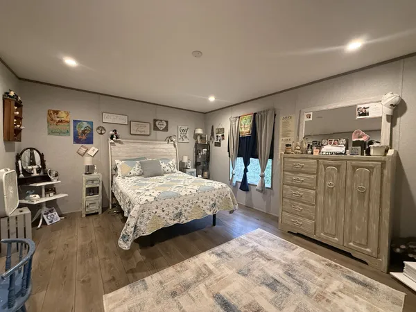 a bedroom with a large bed and furniture
