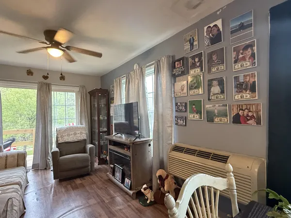 a bedroom with furniture and a large window