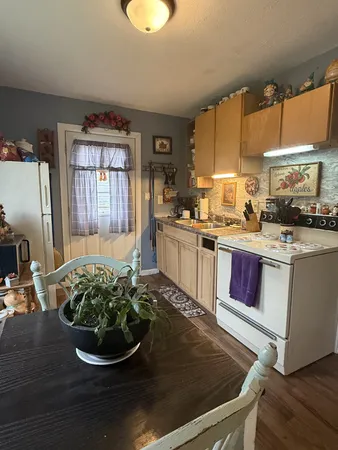 a kitchen with a stove a sink and a cabinets