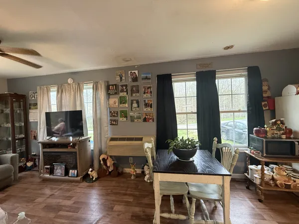 a living room with furniture a fireplace and a flat screen tv