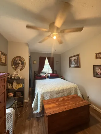 a bed sitting in a room next to a window