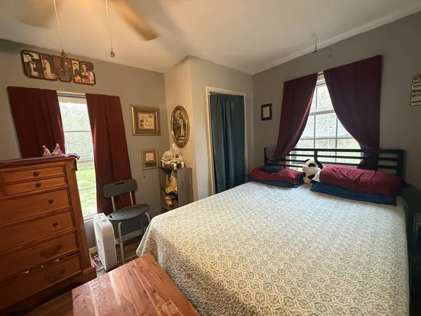 a bed room with a bed and a television