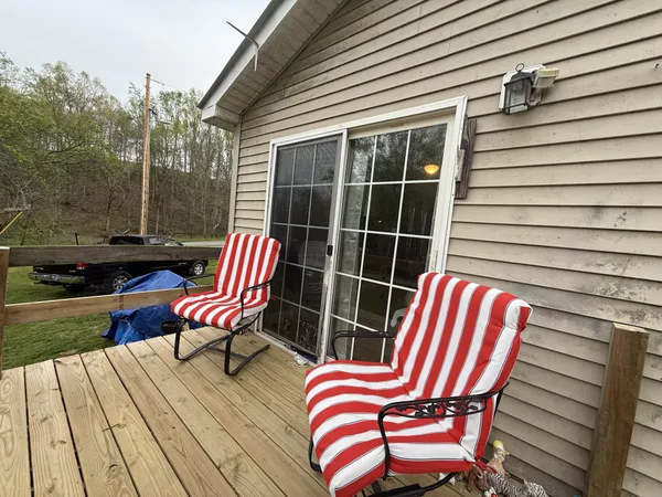 a view of a wooden chairs in the patio