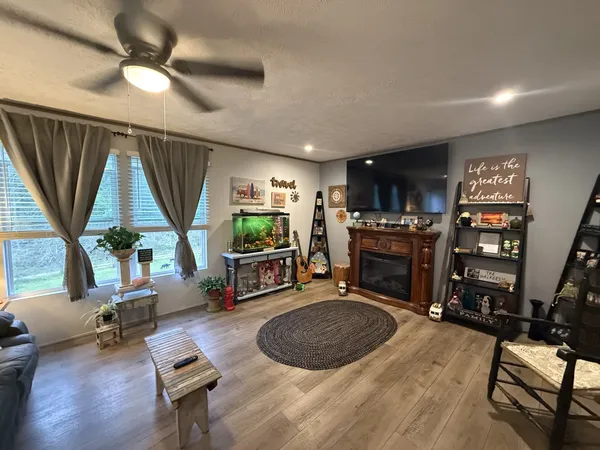 a living room with furniture a window and a flat screen tv